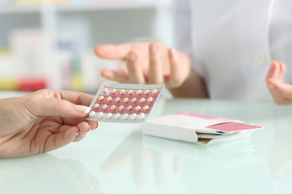 someone handing over a blister of pills